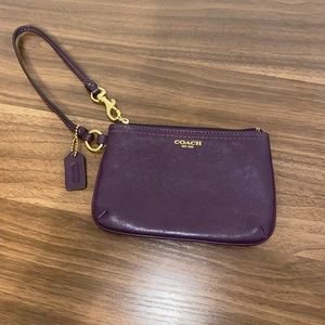 Purple coach wristlet with gold accents